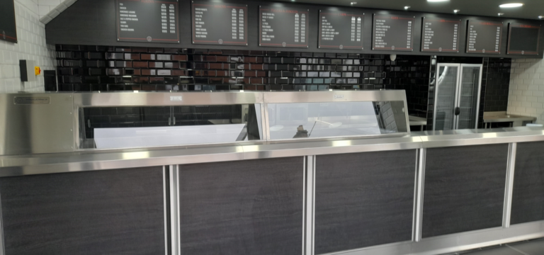 Modern interior of Balmoral Chippy with serving counter and menu boards